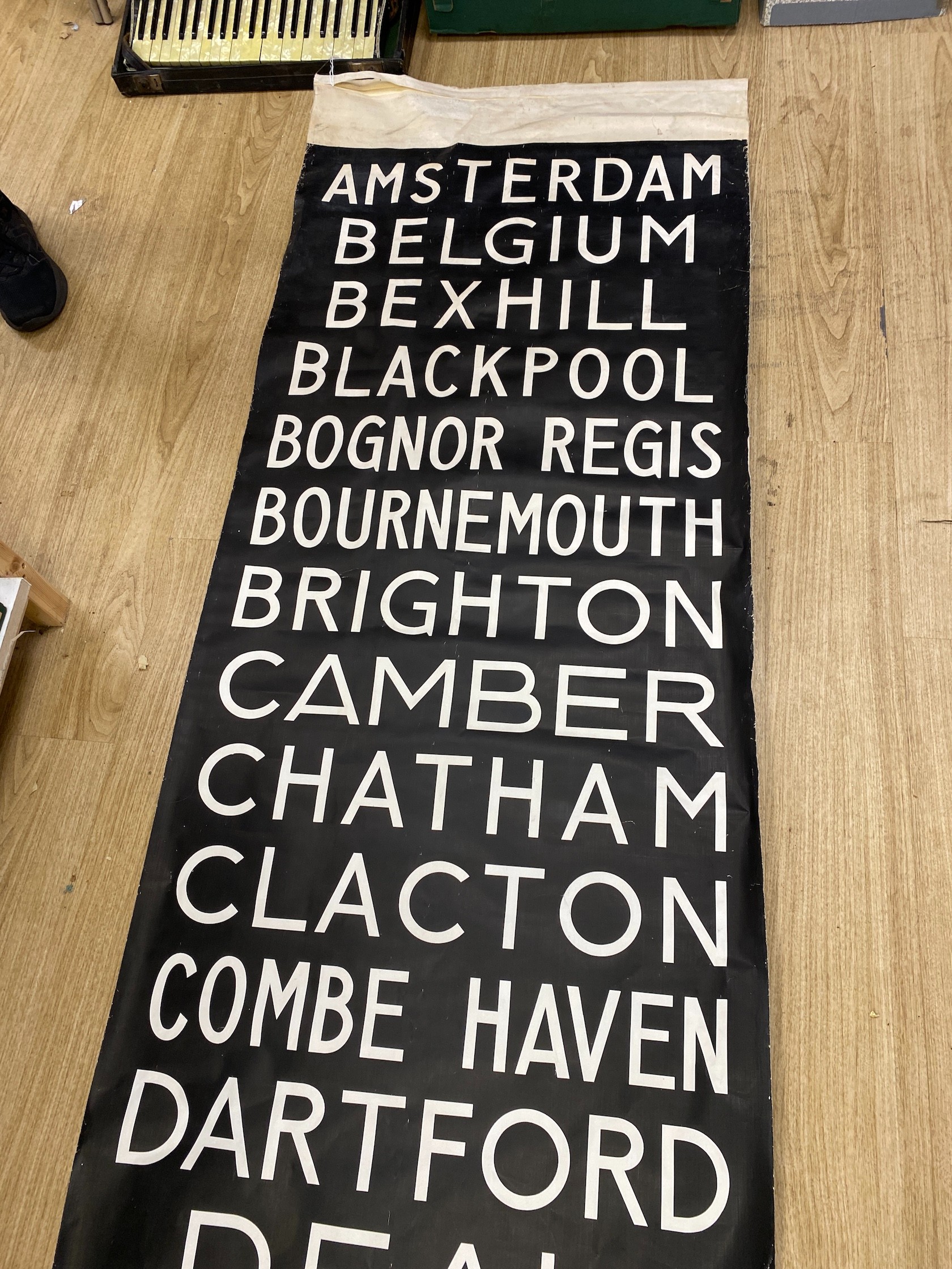 A painted canvas alphabetical list of European destinations including Sussex areas such as Brighton approximately 695x80cm